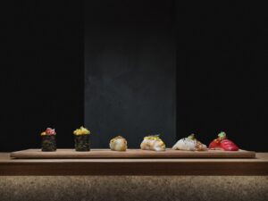 Variados hand rolls y sushi en un elegante plato de madera