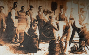 Grupo de trabajadores en una bodega antigua en el patio.
