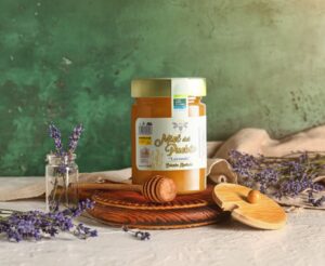 Tarro de miel de lavanda con flores de lavanda y cuchara de madera