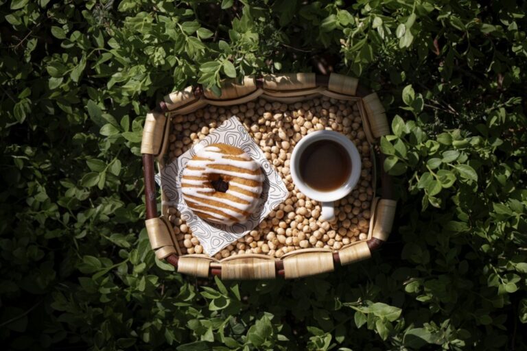 Donut de cocido vasco con café en una bandeja sobre hierbas