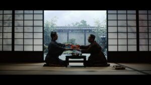 Dos personas en un ambiente japonés intercambiando barritas de surimi.