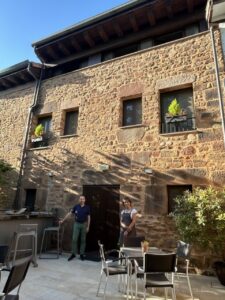 Fachada del hotel Rural Pura Vida en Valgañón con dos personas en la entrada.