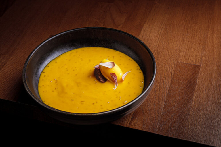 Deliciosas natillas de mango y tapioca en un plato negro