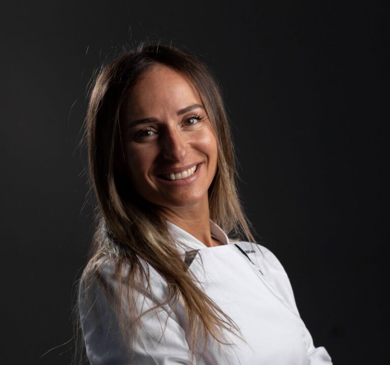 Celeste de la Banda sonriente en su vestimenta de chef