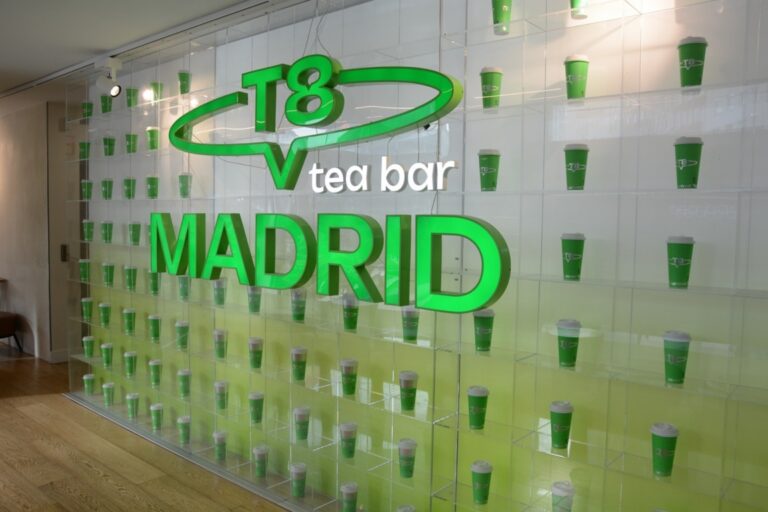 Interior del T8 Tea Bar en Madrid con vasos de té en exhibición.