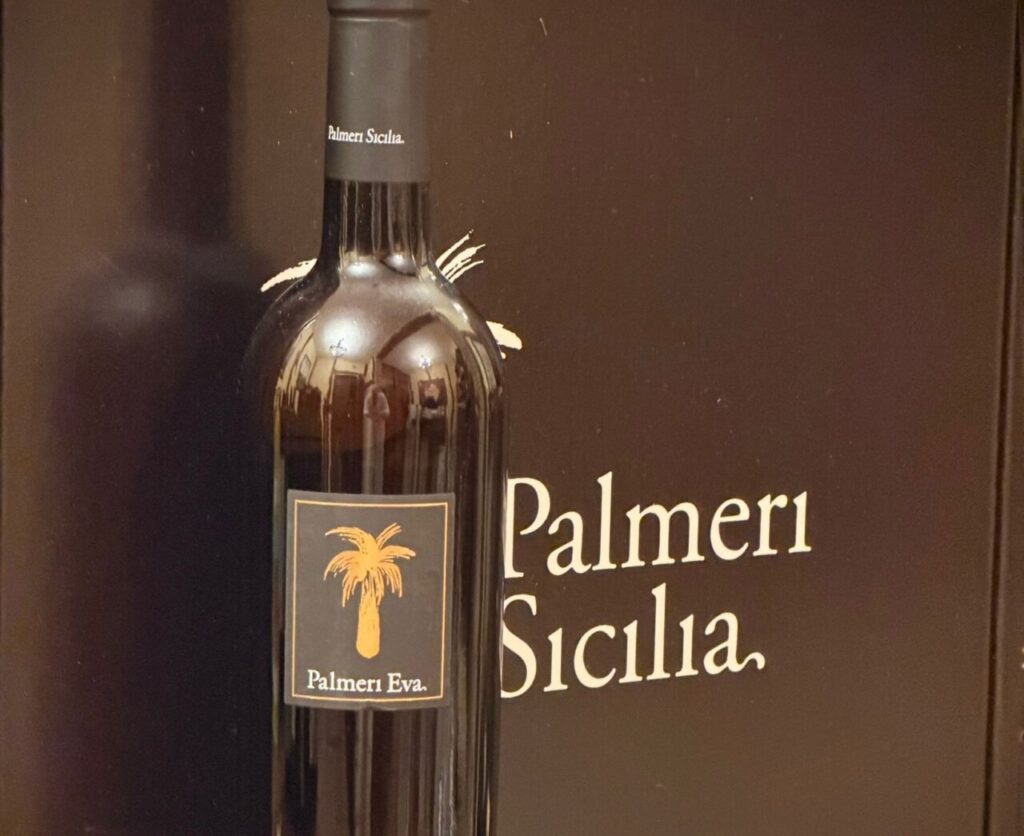 Botella de vino Palmeri Eva sobre fondo negro con logo